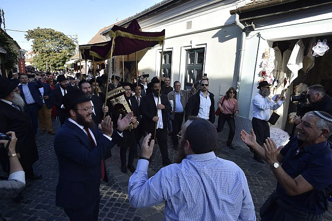 Rabbi Shlomo Koves (left) rejoices with the Budapest Jewish community as it celebrates two new Torah scrolls and synagogue openings in Hungary, on Sept. 22, 2019. Credit: Zsolt Demecs.