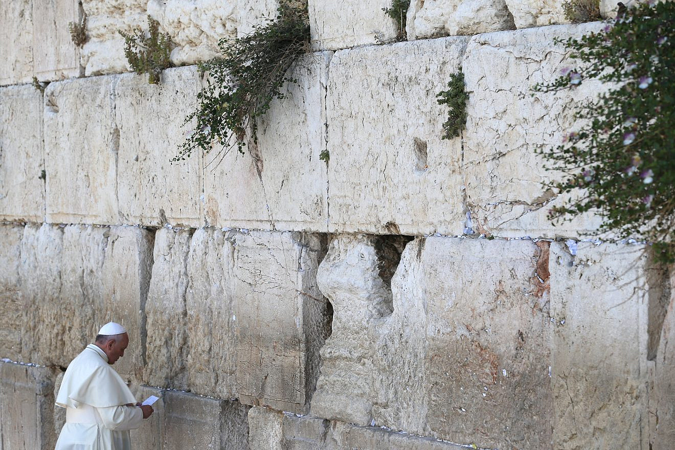 Pope Francis prepares to place a note in a crack of the Western Wall in Jerusalem, May 26, 2014. Photo by Nati Shohat/Flash90.