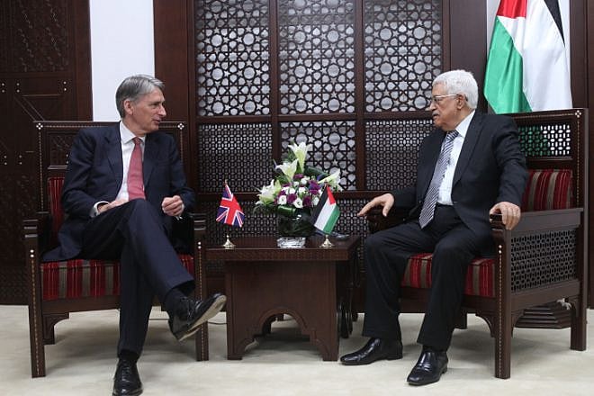 Palestinian Authority leader Mahmoud Abbas (right) meets with British Foreign Secretary Philip Hammond in the West Bank city of Ramallah on July 23, 2014. Photo by Issam Rimawi/Flash90.