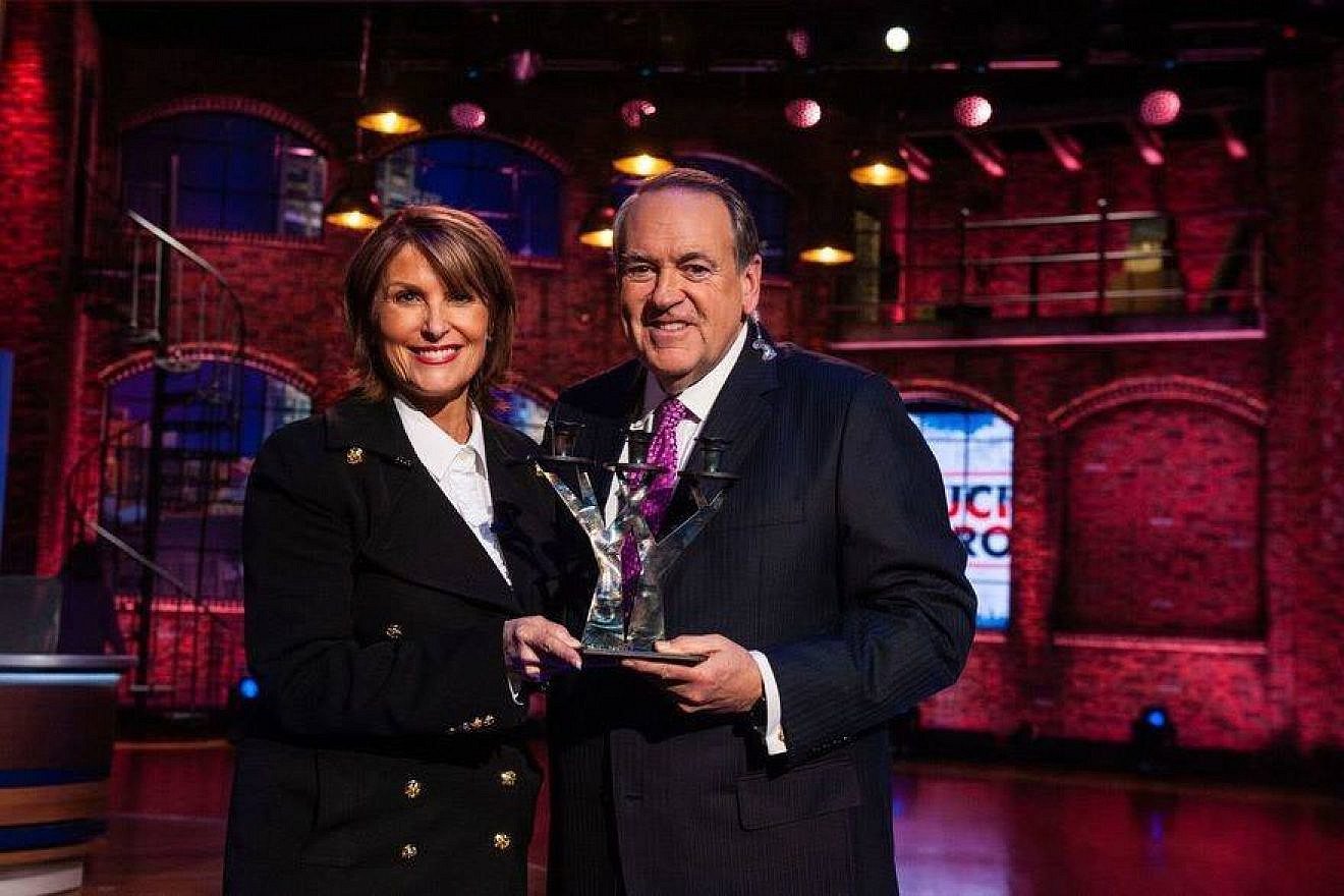 Laurie Cordoza-Moore, president of Proclaiming Justice to the Nations, with former Arkansas Gov. Mike Huckabee. Source: Facebook via PJTN.
