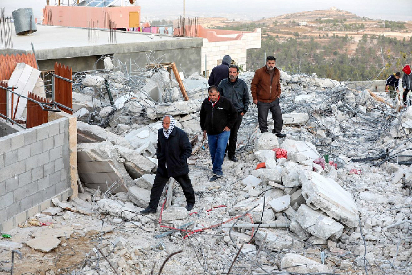 Palestinians inspect the damage following the demolition by Israel of the family home of a suspect in the murder of Dvir Sorek, in the village of Beit Kahel near Hebron, Nov. 28, 2019. Photo by Wisam Hashlamoun/Flash90.