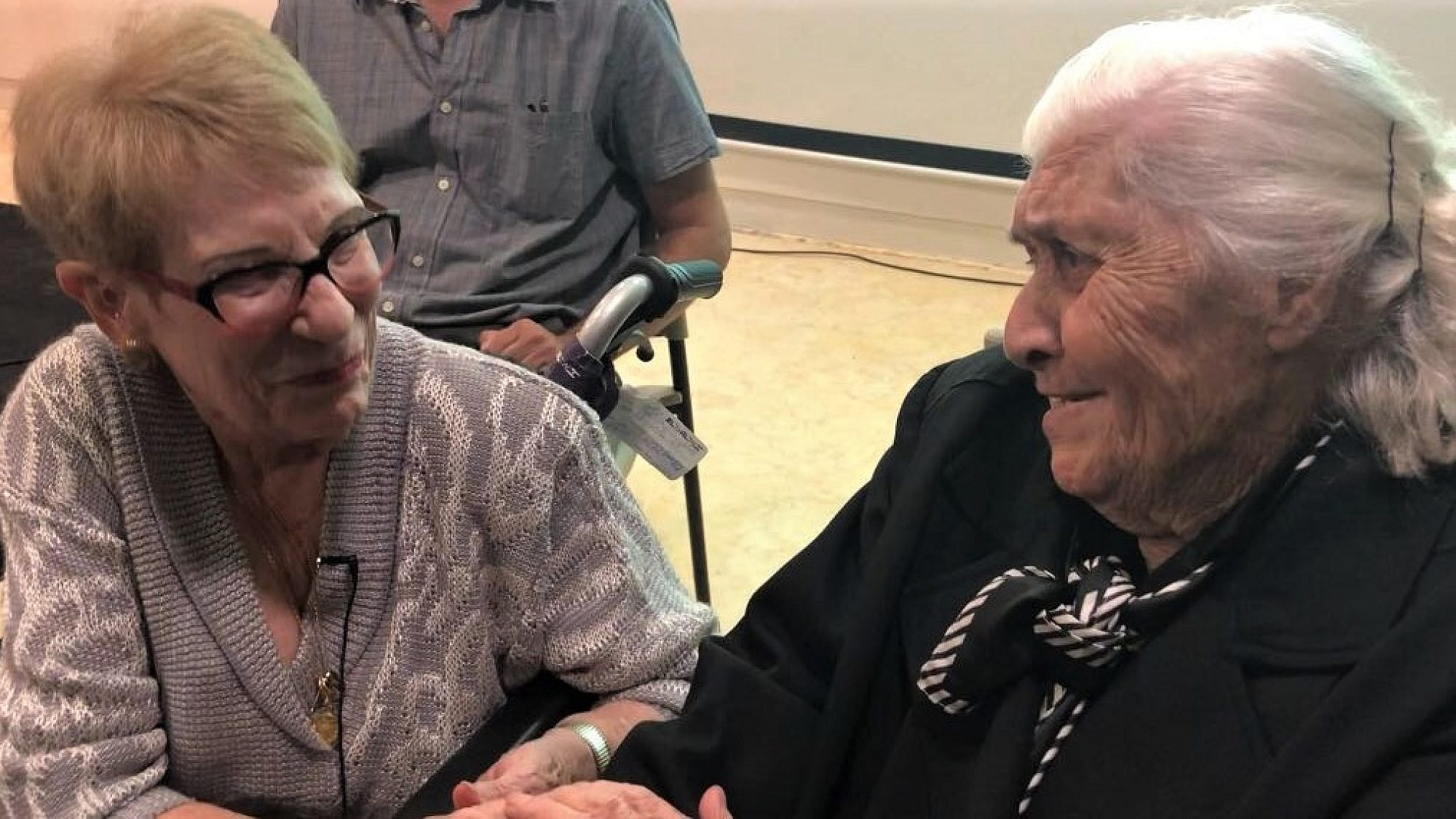 At the Hall of Names in Yad Vashem in Jerusalem, Greek rescuer Melpomeni Dina, 92, reunites with (left) Sarah Yanai, 86, one of the survivors she saved during the Holocaust, Nov. 3, 2019. Photo by Eliana Rudee.