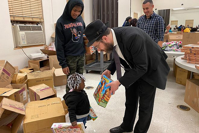 Black and Jewish volunteers in the Jersey City neighborhood of Greenville on Monday partnered up on a charity drive to deliver food and other goods to hundreds of local families in need. Source: Chesky Deutsch via Twitter.