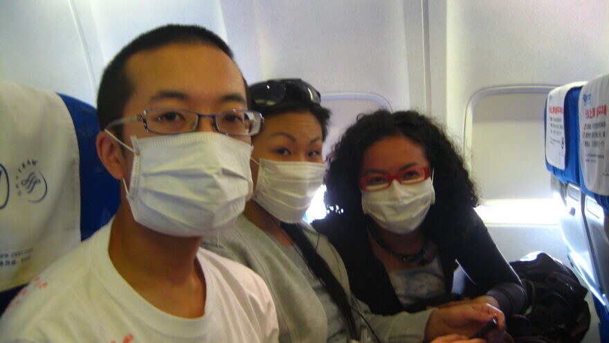 Chinese travelers wear masks as a precaution against infection. Credit: David Woo via Flickr.