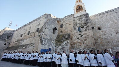 Clergymen gather in the Manger Square outside the Church of  Nativity in the city of Bethlehem on Dec. 24, 2012. Photo by Issam Rimawi / Flash90.
