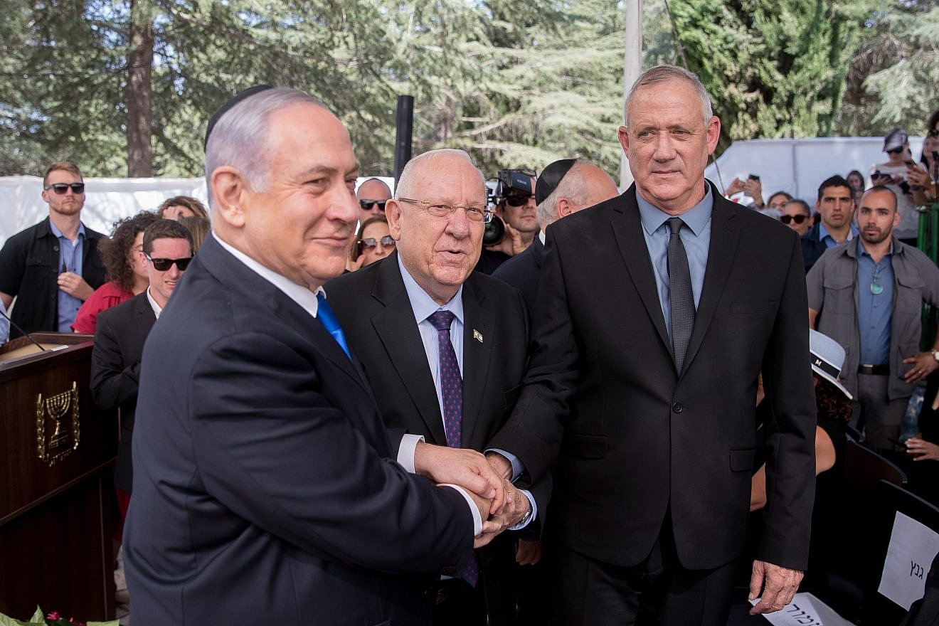 From left: Israeli Prime Minister Benjamin Netanyahu, President Reuven Rivlin and Blue and White Party leader Benny Gantz shake hands at the memorial ceremony for the late President Shimon Peres, at the Mount Herzl cemetery in Jerusalem, on Sept. 19, 2019. Photo by Yonatan Sindel/Flash90.