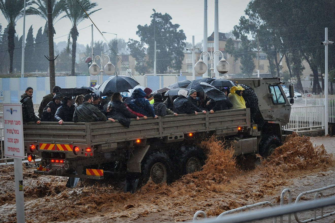 A military truck evacuates Israeli citizens through a flooded road in the northern Israeli city of Nahariya on Jan. 8, 2020. Photo by Meir Vaknin/Flash90.
