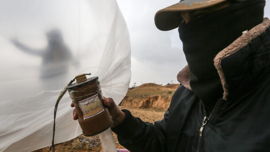 Palestinians prepare a flammable object to be flown towards Israel, near the border with the Gaza Strip, on Jan. 18, 2020. Photo by Abed Rahim Khatib/Flash90.