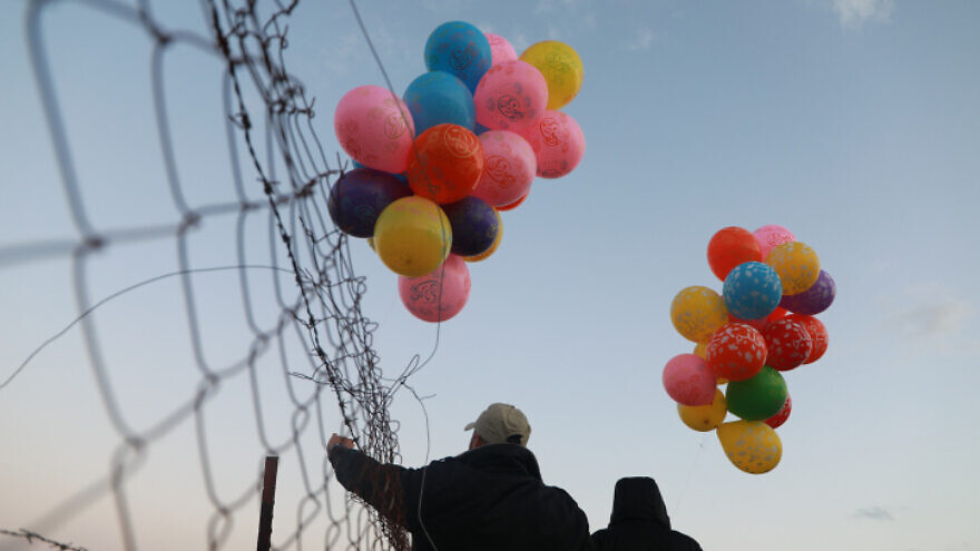 Young Palestinian men prepare an incendiary device to be launched into Israel near the Israel-Gaza border, Jan. 22, 2020. Photo by Ail Ahmed/Flash90.