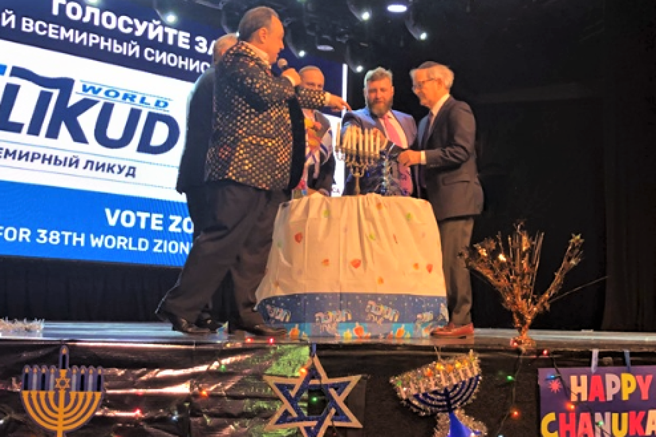 Russian-speaking division leaders Vlad Lipkin and Ben Kogan light the Hanukkah menorah  in front of 1,300 supporters at Master Theater in Brighton Beach, N.Y., on Dec. 26, 2019. Photo by Helen Kogan.