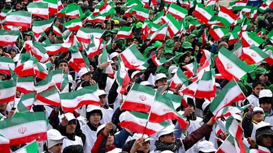 Iranians celebrate the anniversary of the Islamic Revolution in Mashhad, Iran, in 2014. Credit: Wikipedia.