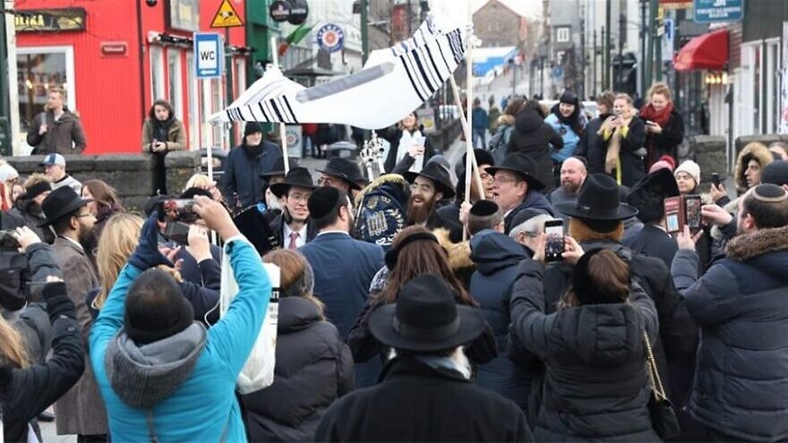 Celebrants dance down the streets of Reykjavik, the capital of Iceland, to mark the completion and inauguration of a Torah scroll on the European island. Photo by Gabriel Rutenberg/Chabad.org/News.