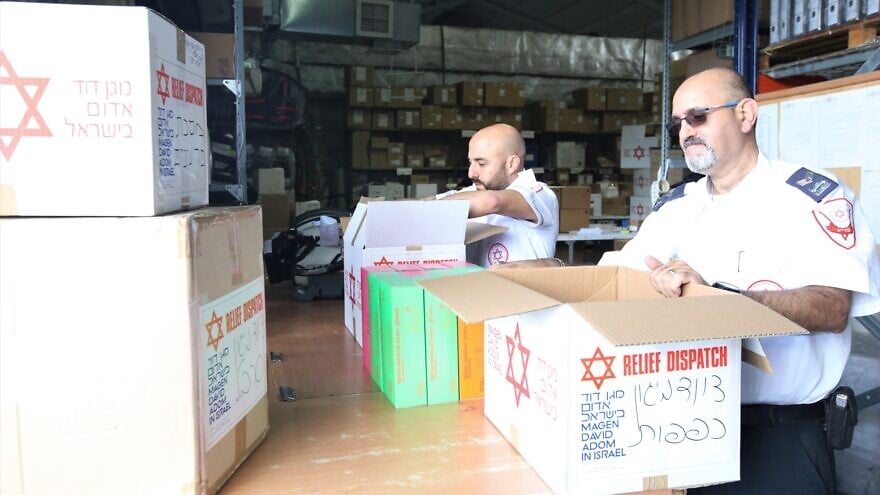 Representatives from the Israeli emergency medical services’ organization Magen David Adom pack boxes of protective gear, responding to a request by Chabad to help communities in China amid the coronavirus outbreak, February 2020. Credit: Courtesy.