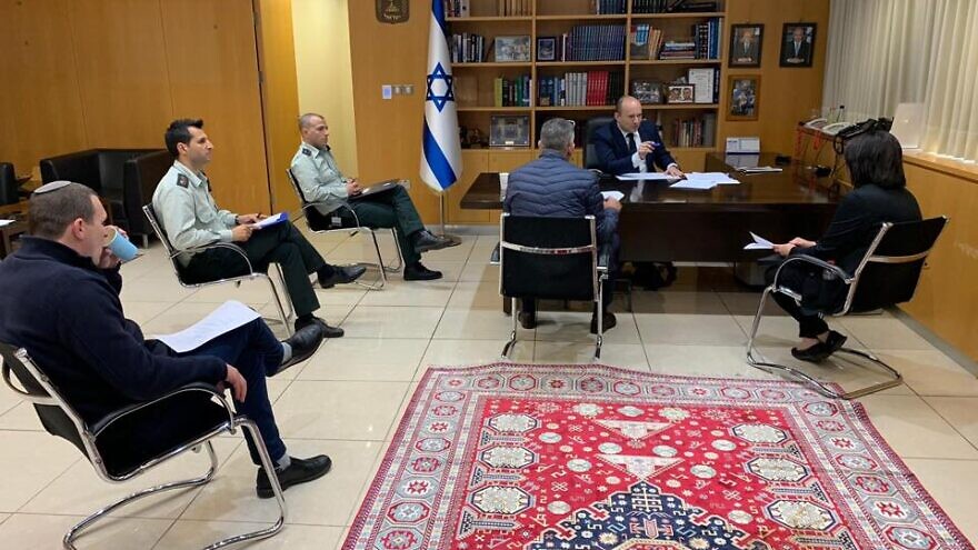 Israeli Defense Minister Naftali Bennett meets with defense officials to discuss new protocols regarding Israelis who have been diagnosed with the coronavirus, COVID-19. Credit: Naftali Bennett via Facebook.