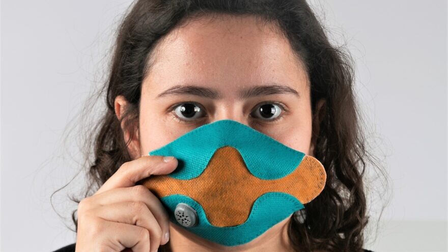 Yael Mordechay, a student in the industrial design department of the Bezalel Academy of Art and Design in Jerusalem, displays the protection mask against bacteria and viruses that she designed. Credit: Courtesy.