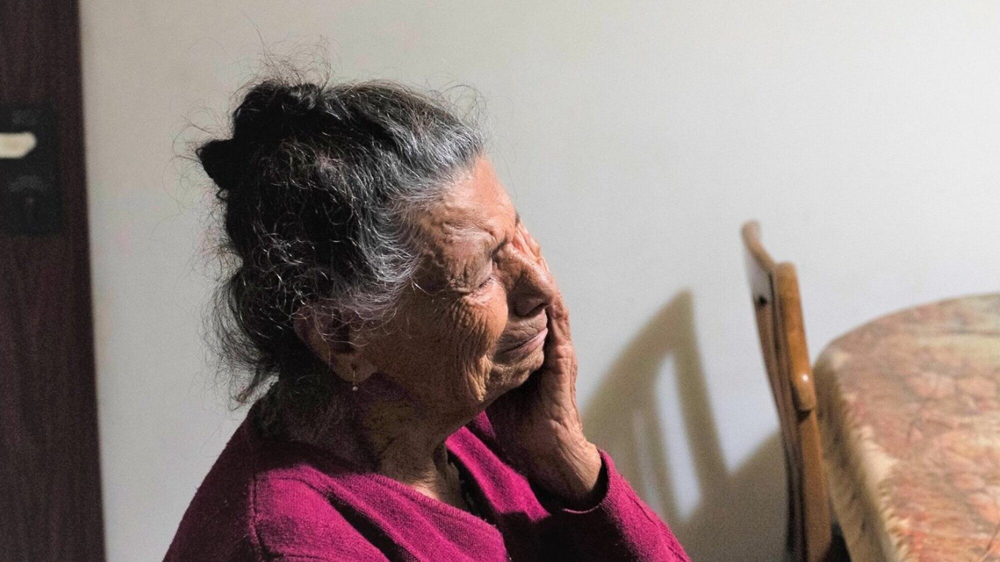 A homebound elderly woman in Israel feeling the isolation. Credit: IFCJ.