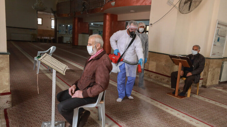 Palestinian workers disinfect a mosque in Ramallah as a preventive measure against the coronavirus on March 7, 2020. Photo by Flash90.