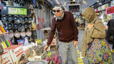 Israelis leave home under mandatory quarantine due to the coronavirus to shop for food at the Mahane Yehuda Market in Jerusalem on March 19, 2020. Photo by Yossi Zamir/Flash90.