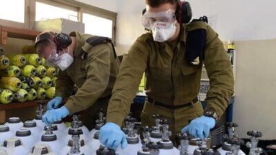 Israel Defense Forces’ soldiers help fill and deliver oxygen tanks as part of the country’s efforts to combat the coronavirus pandemic. Credit: IDF Spokesperson’s Unit.