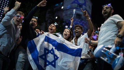 People wear Israeli flags as they take part in celebrations marking Israel's 71st Independence Day in Jerusalem on May 8, 2019. Photo by Hadas Parush/Flash90.