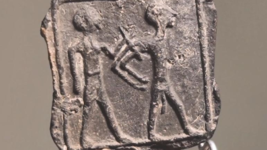 The tablet discovered in March 2020 that shows a Canaanite captor controlling a Canaanite captive. Credit: Israel Antiquities Authority.