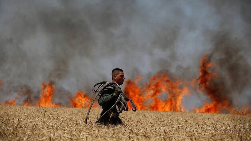 Israeli firefighters put out flames in southern Israel near the border with the Gaza Strip in 2019. Credit: JNF-USA.