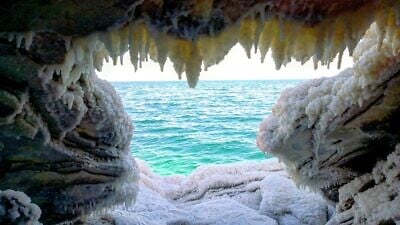 A view of the Dead Sea from inside a cave covered in salt and other minerals. Credit: Noam Bedein/deadsearevival.org.