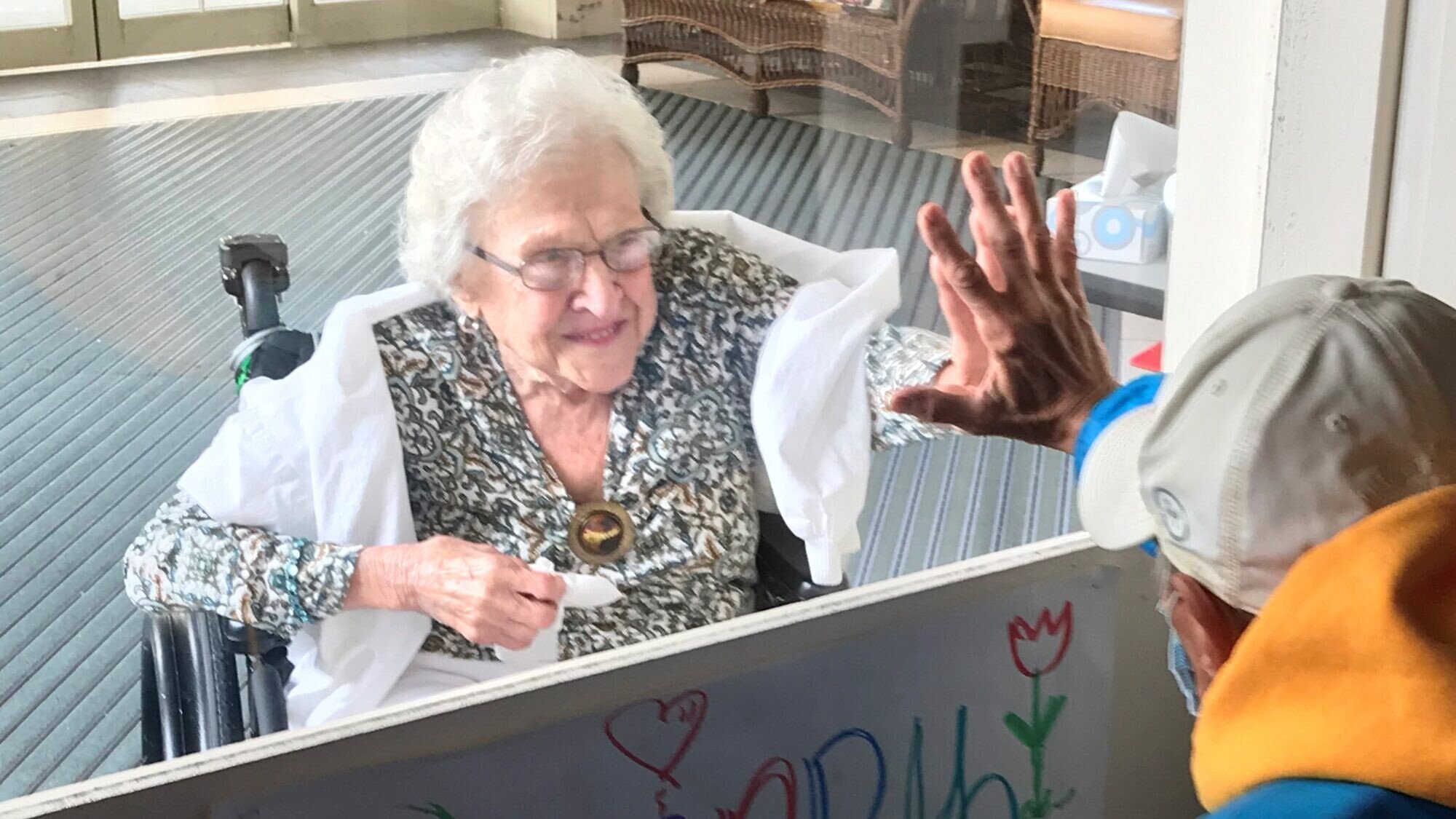 A family member visits an elderly resident at a senior facility run by the Jewish Association on Aging in Pittsburgh. Credit: Courtesy.
