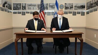 U.S. Secretary of Defense Mark Esper and Israeli Defense Minister Benny Gantz sign an agreement that Gantz said will “ensure the quality edge of the Israeli defense establishment and the IDF in the coming decades.” Credit: Israeli Ministry of Defense.