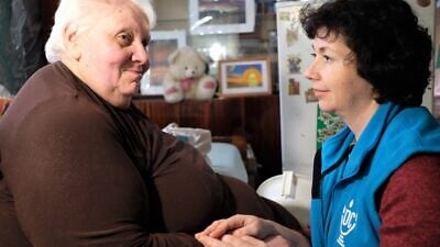 Liudmila Starikovich in Belarus with her JDC homecare worker before the onset of the coronavirus pandemic. Courtesy: JDC.