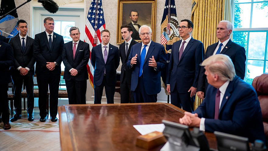 U.S. President Donald Trump listens as U.S. Ambassador to Israel David Friedman addresses his remarks in the Oval Office at the announcement that Bahrain is joining the United Arab Emirates in normalizing relations with Israel. on Sept. 11, 2020. Credit: Official White House Photo by Tia Dufour.