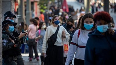 Jerusalemites wearing a face mask walk in Jerusalem City Center on November 29, 2020, as Israel steps out of coronavirus lockdown and rolls back restrictions. Photo by Olivier Fitoussi/Flash90