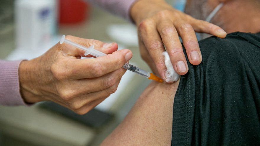 A COVID-19 vaccination is administered at a Maccabi Healthcare Services vaccination center in Modi'in on Dec. 24, 2020. Photo by Yossi Aloni/Flash90.