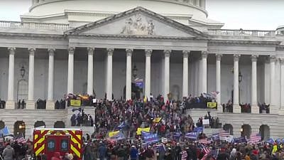 Supporters of President Donald Trump at the U.S. Capitol, where hundreds smashed windows and broke into the building while protesting the results of the November elections, Jan. 6, 2021. Source: YouTube.
