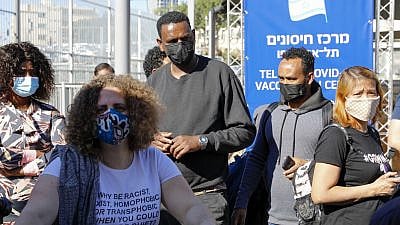 Foreign nationals wait in line for a coronavirus vaccine in Tel Aviv on Feb. 9, 2021. Credit: Tel Aviv Municipality/Guy Yechiely.
