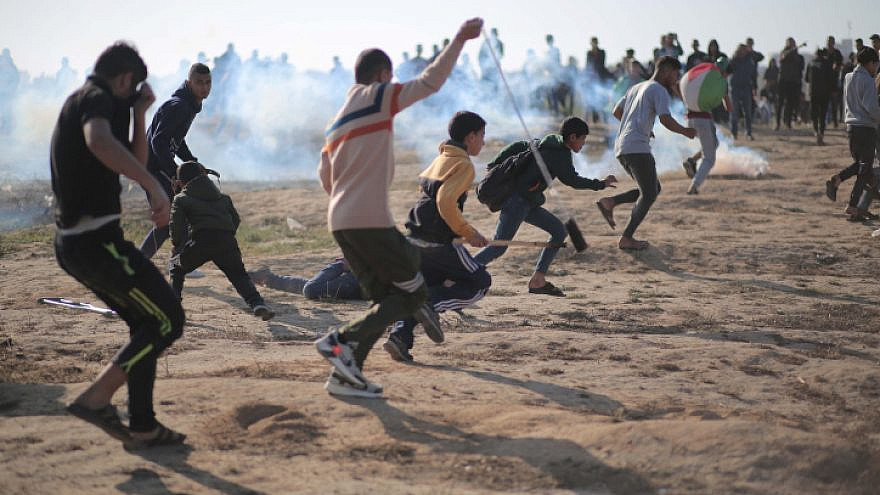Palestinians take part in riots on the Gaza border, slinging stones at Israeli security forces, March 2021. Photo by Hassan Jedi/Flash90.