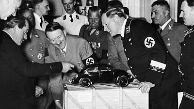 Adolf Hitler and Porsche company founder Ferdinand Porsche (left) ogle a model of the original Volkswagen Beetle. Credit: JNS File Photo.