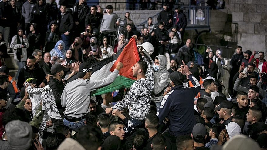 Arabs wave Palestinian flags at the Damascus Gate in Jerusalem's Old City during the holy Muslim month of Ramadan, April 26, 2021. Photo by Olivier Fitoussi/Flash90.