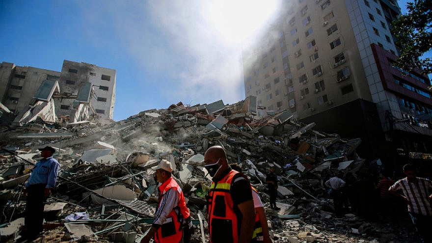 Debris from the Al-Jalaa tower in Gaza City after an Israeli airstrike, which according to the Israel Defense Forces housed Hamas intelligence and weaponry, in the midst of conflict with Israel. Several media outlets also had offices in the building, including the Associated Press and Al Jazeera, May 15, 2021. Photo by Atia Mohammed/Flash90.