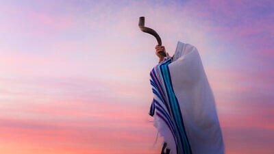 A man blowing a shofar. Credit: John Theodor/Shutterstock.
