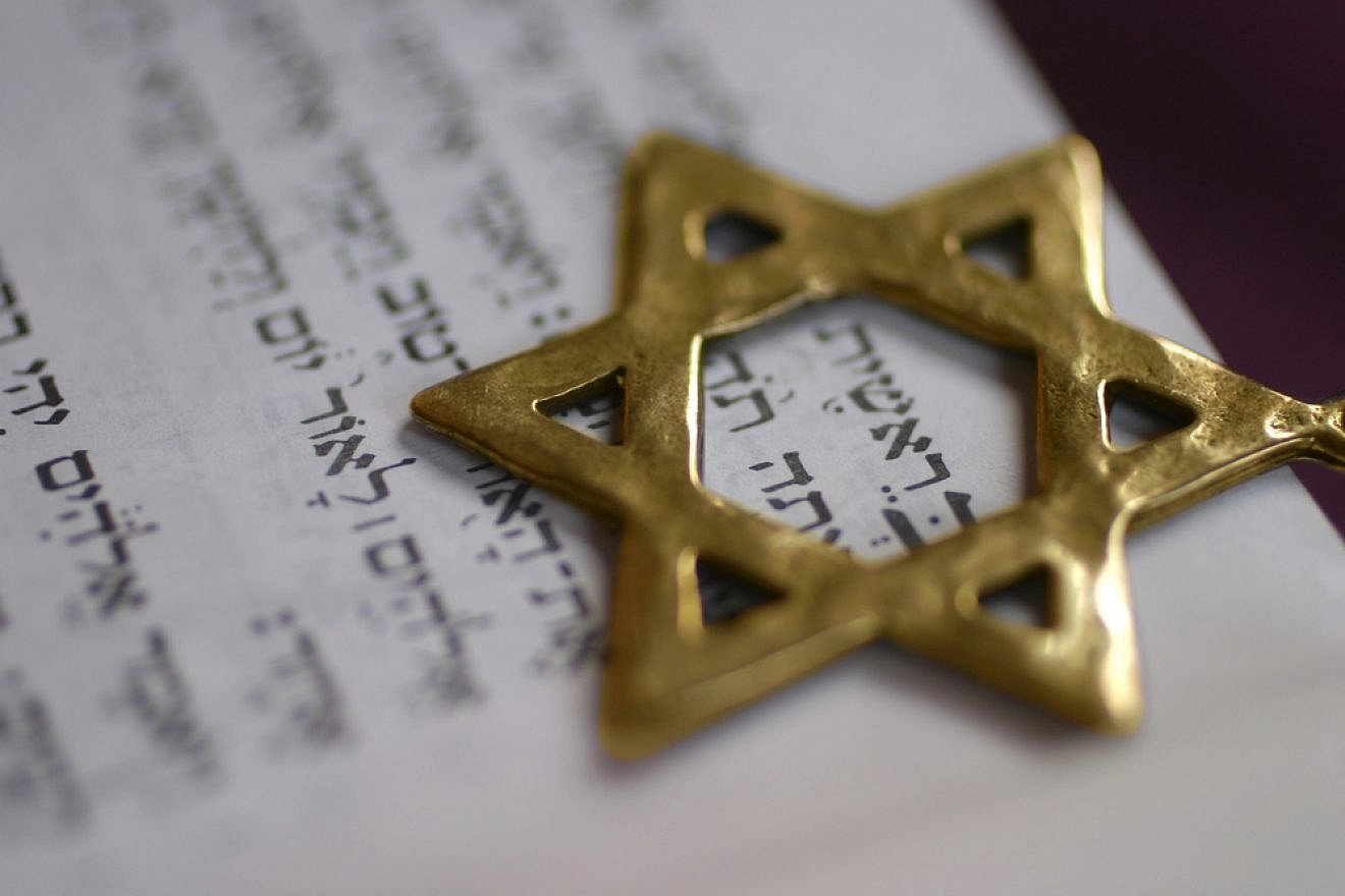 A Star of David pointer over the first word of the book of Genesis. Credit: Odelia Cohen/Shutterstock.