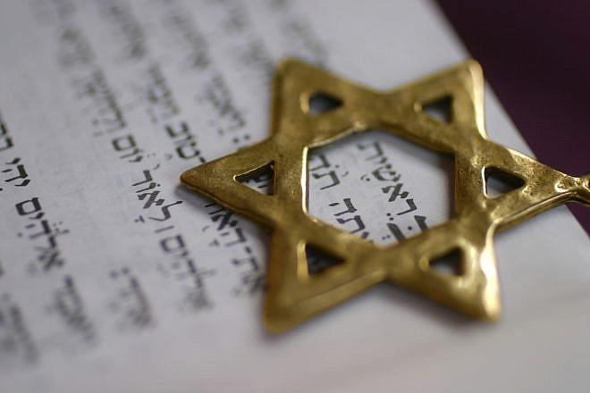 A Star of David pointer over the first word of the book of Genesis. Credit: Odelia Cohen/Shutterstock.