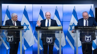 Israeli Prime Minister Naftali Bennett (center), Foreign Affairs Minister Yair Lapid (left) and Finance Minister Avigdor Liberman give a press conference in Jerusalem on Nov. 6, 2021. Photo by Ohad Zwigenberg/POOL.