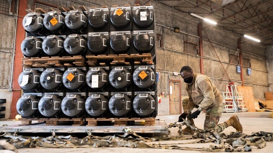Airman 1st Class Olabode Igandan, a 436th Aerial Port Squadron passenger-services apprentice, palletizes ammunition, weapons and other equipment bound for Ukraine at Dover Air Force Base, Delaware, on Jan. 21, 2022. Credit: U.S. Air Force Photo by Mauricio Campino via Wikimedia Commons.