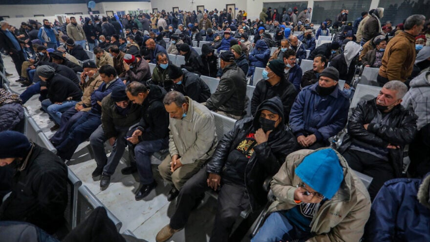 Palestinian workers at the Erez border crossing in Beit Hanun in the northern Gaza Strip as they wait to enter Israel for work on March 13, 2022. Photo by Attia Muhammed/Flash90.