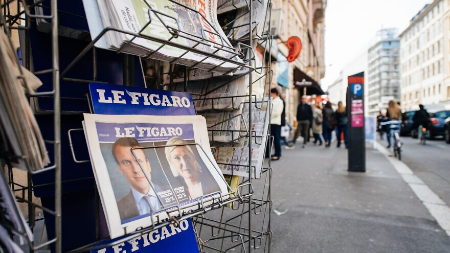 A kiosk in France shows French presidential election candidates incumbent Emmanuel Macron and challenger Marine Le Pen, April 24, 2022. Credit: Hadrian/Shutterstock.