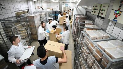 Preparing food packages for Passover 2022. Credit: Pantry Packers.