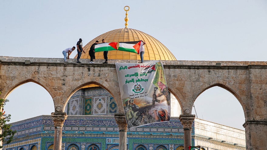 Palestinians protest as thousands attend prayers at the Al-Aqsa mosque on the Temple Mount marking the Muslim holiday of Eid al-Adha, July 20, 2021. Photo by Jamal Awad/Flash90.