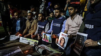 Palestinian journalists take part in a candlelight vigil in the Gaza Strip in memory of Al-Jazeera journalist Shireen Abu Akleh, who was killed during a raid of Israeli security forces in the West Bank city of Jenin on May 11, 2022. Photo by Abed Rahim Khatib/Flash90.