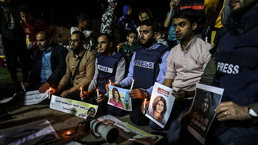 Palestinian journalists take part in a candlelight vigil in the Gaza Strip in memory of Al-Jazeera journalist Shireen Abu Akleh, who was killed during a raid of Israeli security forces in the West Bank city of Jenin on May 11, 2022. Photo by Abed Rahim Khatib/Flash90.